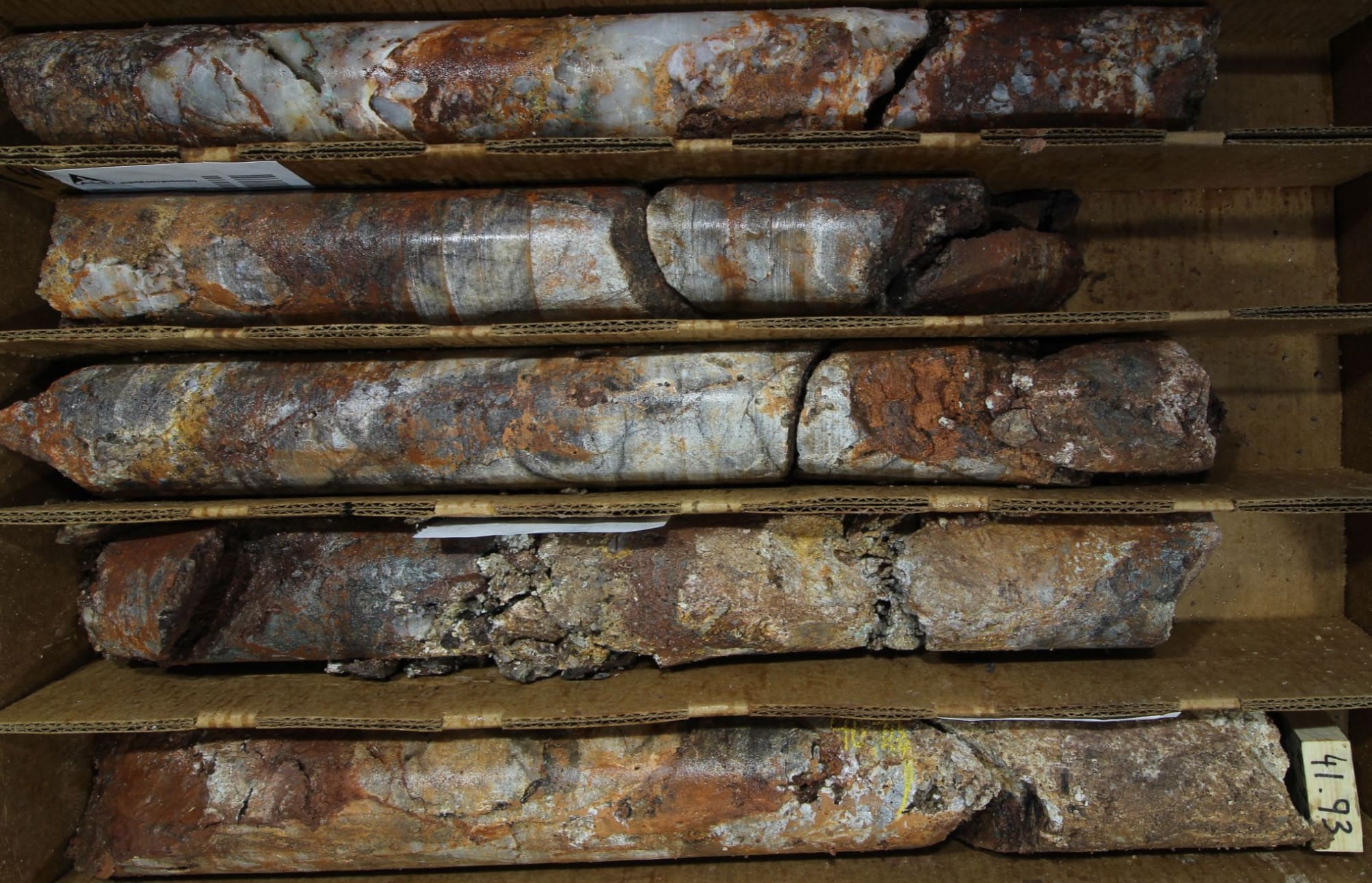 Oxidation of vein sulfide minerals within hematite-diopside skarn replacement zones  zones peripheral to broad quartz veins found in altered limestone host rock at the margins of stockwork-veined quartz dacite porphyry sills in the top 300m of Hole 001 (Hole 001; 39-42 m interval; HQ core).